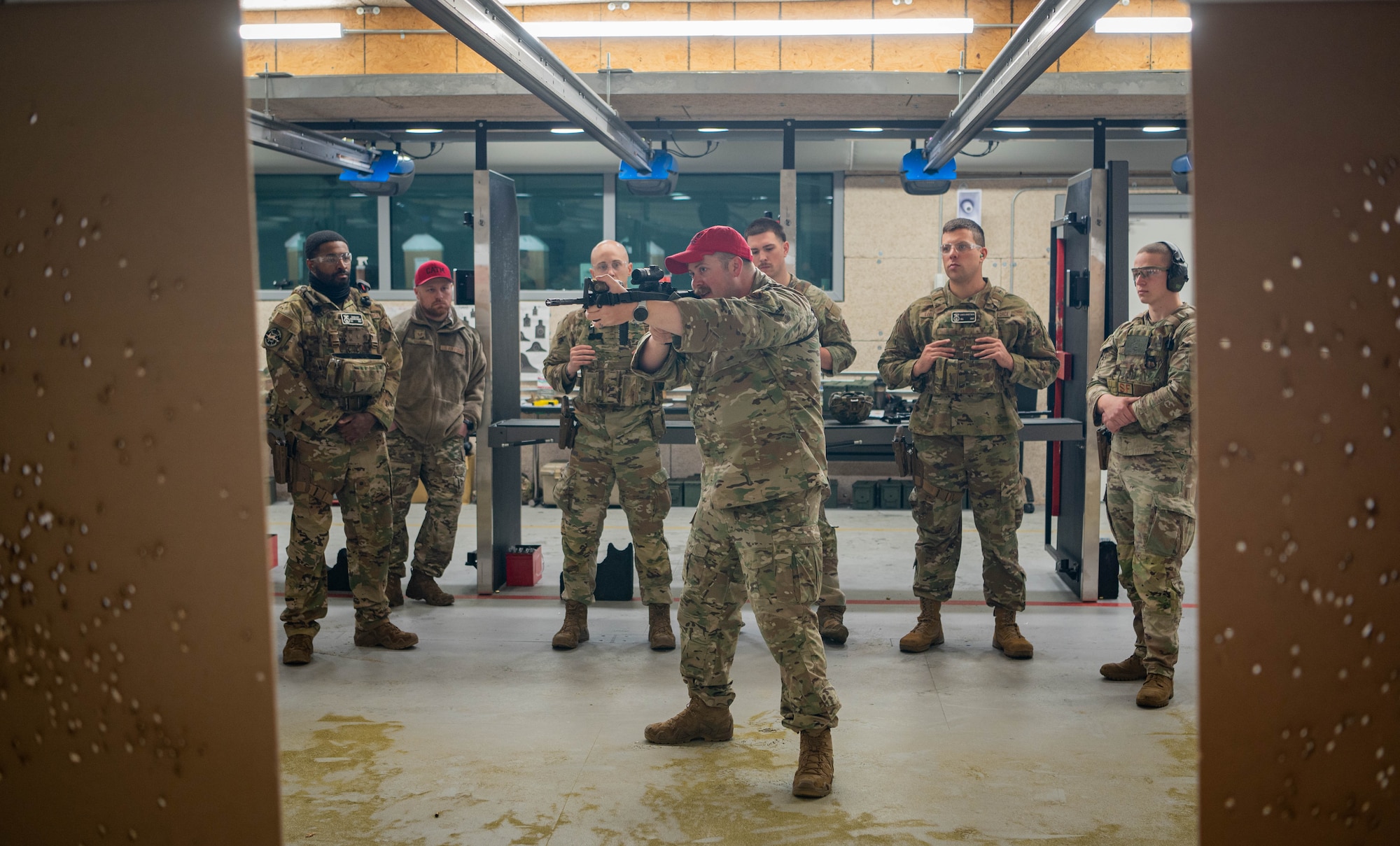 Tech. Sgt. Cody Fiecke, 55th Security Forces Squadron Combat Arms Training and Maintenance trainer, demonstrates M4 rifle tactics to Savage Raider Team candidates at the Offutt firing range March 5, 2025. SRT candidates were assessed on weapons handling with the M4 rifle and M18 handgun. (U.S. Air Force photo by Daniel Martinez)