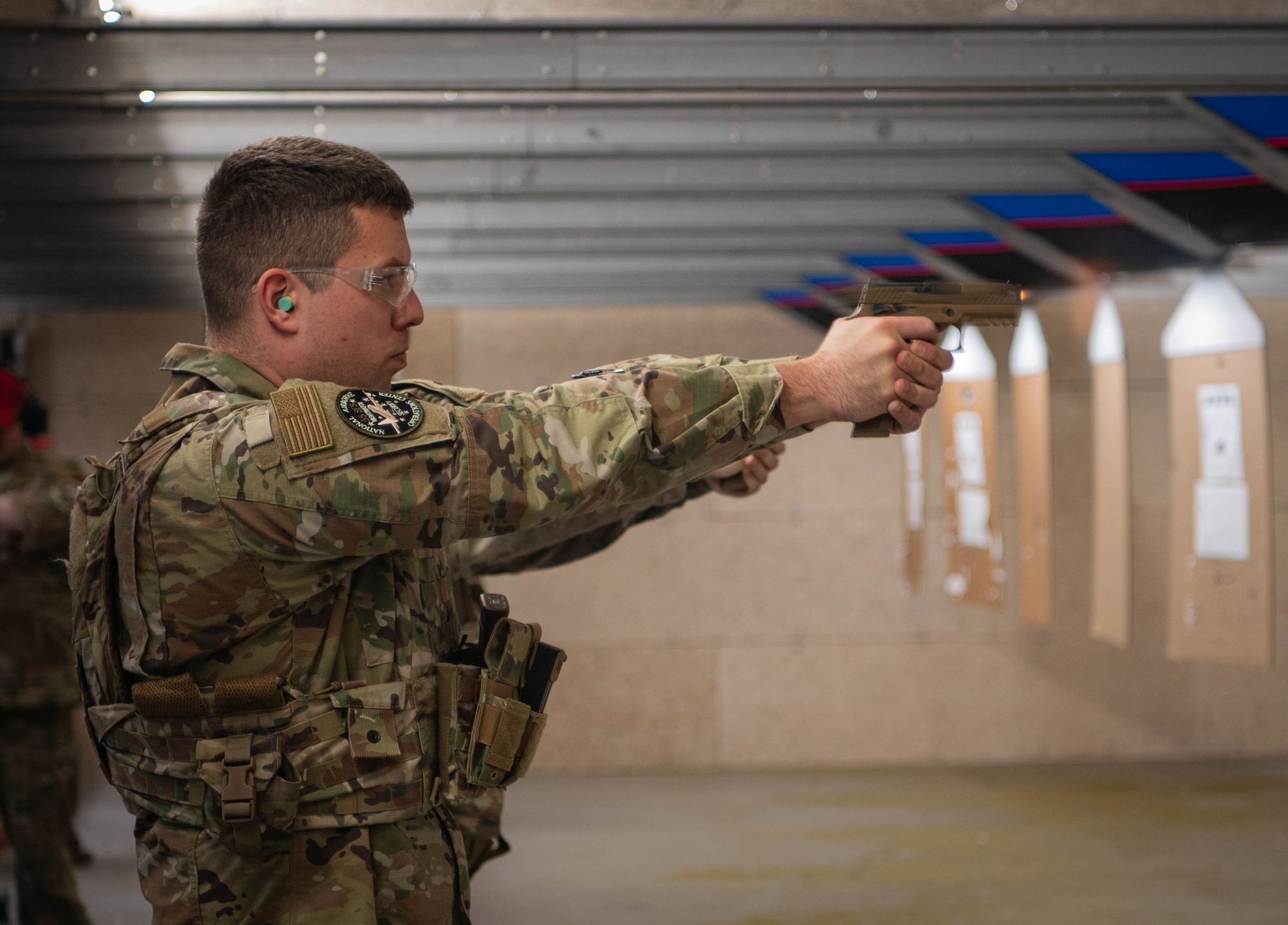 Senior Airman Christopher Sweetman, 55th Security Forces Squadron National Airborne Operations Center member and Savage Raider Team candidate, fires an M18 handgun at a target during SRT tryouts at the Offutt firing range March 5, 2025. SRT candidates were evaluated on weapons handling on the M4 rifle and M18 handgun. (U.S. Air Force photo by Daniel Martinez)