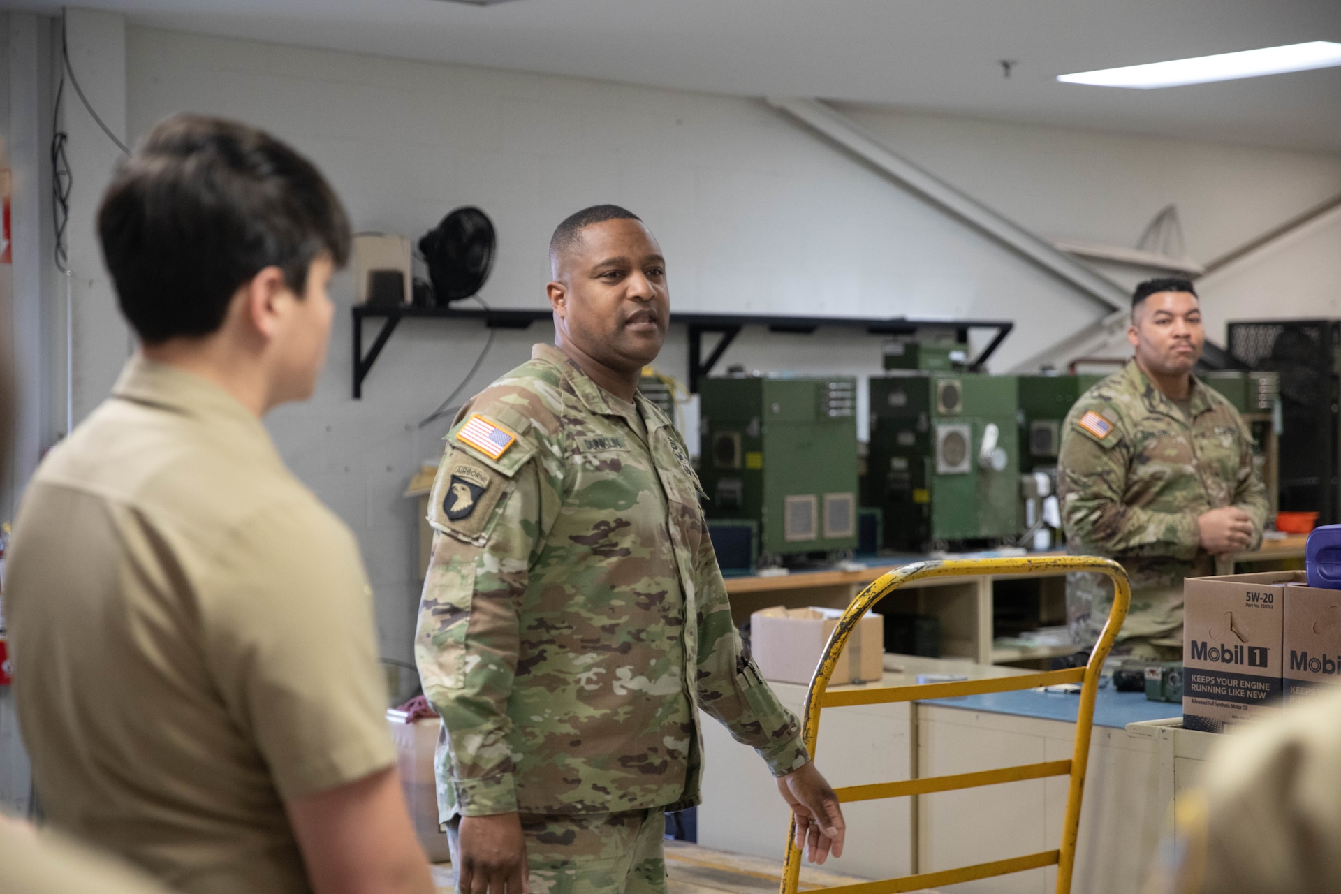 Chief Warrant Officer 2 Yuri Dunklin talks to students with Shawnee Academy’s JROTC program prior to their tour of the Kentucky Army National Guard’s Maneuver Area Training Equipment Site (MATES) at Fort Knox, Mar. 12. The students took part in a hands-on tour of the facilities. They explored maintenance shops, logistics areas, and got up close with military equipment. (U.S. Army National Guard photo by Milt Spalding)