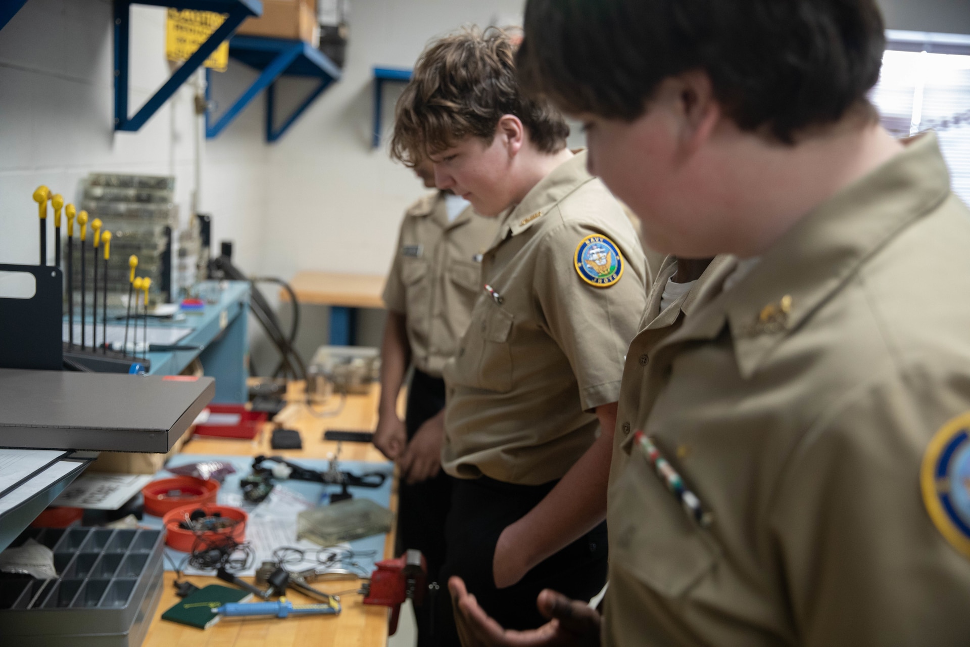 Shawnee Academy JROTC cadets look at electronic equipment during a tour of the Kentucky Army National Guard’s Maneuver Area Training Equipment Site (MATES) at Fort Knox, Mar. 12. The students took part in a hands-on tour of the facilities. They explored maintenance shops, logistics areas, and got up close with military equipment. (U.S. Army National Guard photo by Milt Spalding)