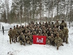 Virginia National Soldiers assigned to the 237th Engineer Company, 276th Engineer Battalion, 329th Regional Support Group, stand together in front of the ‘Eleven Row’ anti-vehicle obstacle they constructed to demonstrate U.S. counter-mobility tactics for Finland’s Kymi Engineer Battalion.