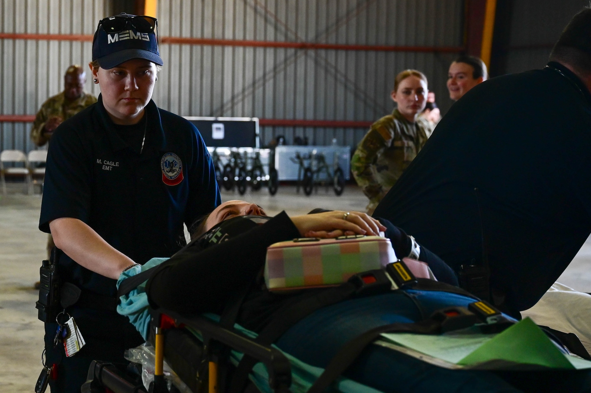 An emergency service member transports a patient.