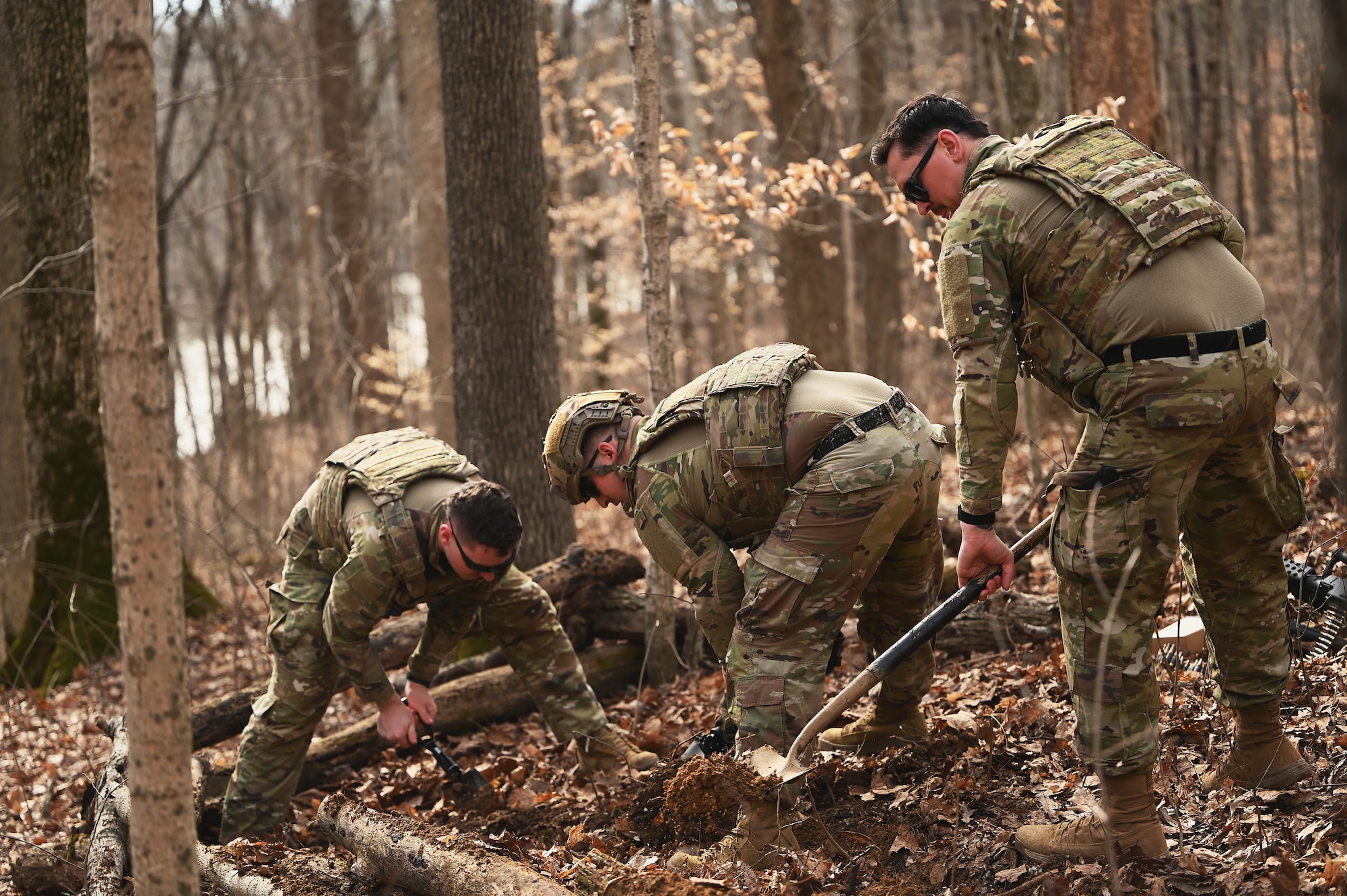 U.S. Airmen assigned to the 178th Security Forces Squadron, Ohio Air National Guard dig defensive fighting positions Feb. 3, 2025 during annual training at Camp Holland in Butlerville, Indiana. The training focused on operational unpredictability enabled through the agility of forces across pre-postured locations, increasing the number of locations an adversary must target. (U.S. Air National Guard photo by Shane Hughes)