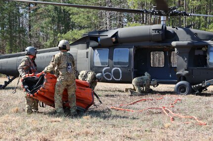Virginia National Guard aviation crews assigned to the 2nd Battalion, 224th Aviation Regiment, 29th Infantry Division, train on aerial fire suppression with UH-60 Black Hawk helicopters equipped with water buckets March 12, 2025, during a prescribed burn at Fort Barfoot, Virginia.