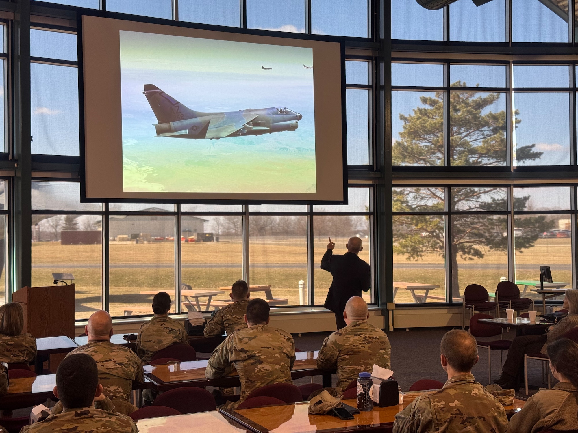 Retired Maj. Gen. Ed Mechenbeier, former Vietnam Prison of War and Air Force pilot, points at his presentation while speaking at the 178th Wing's second Leadership During Novel Events series March 8. Mechenbeier shared his powerful story of resilience, leadership, and teamwork.