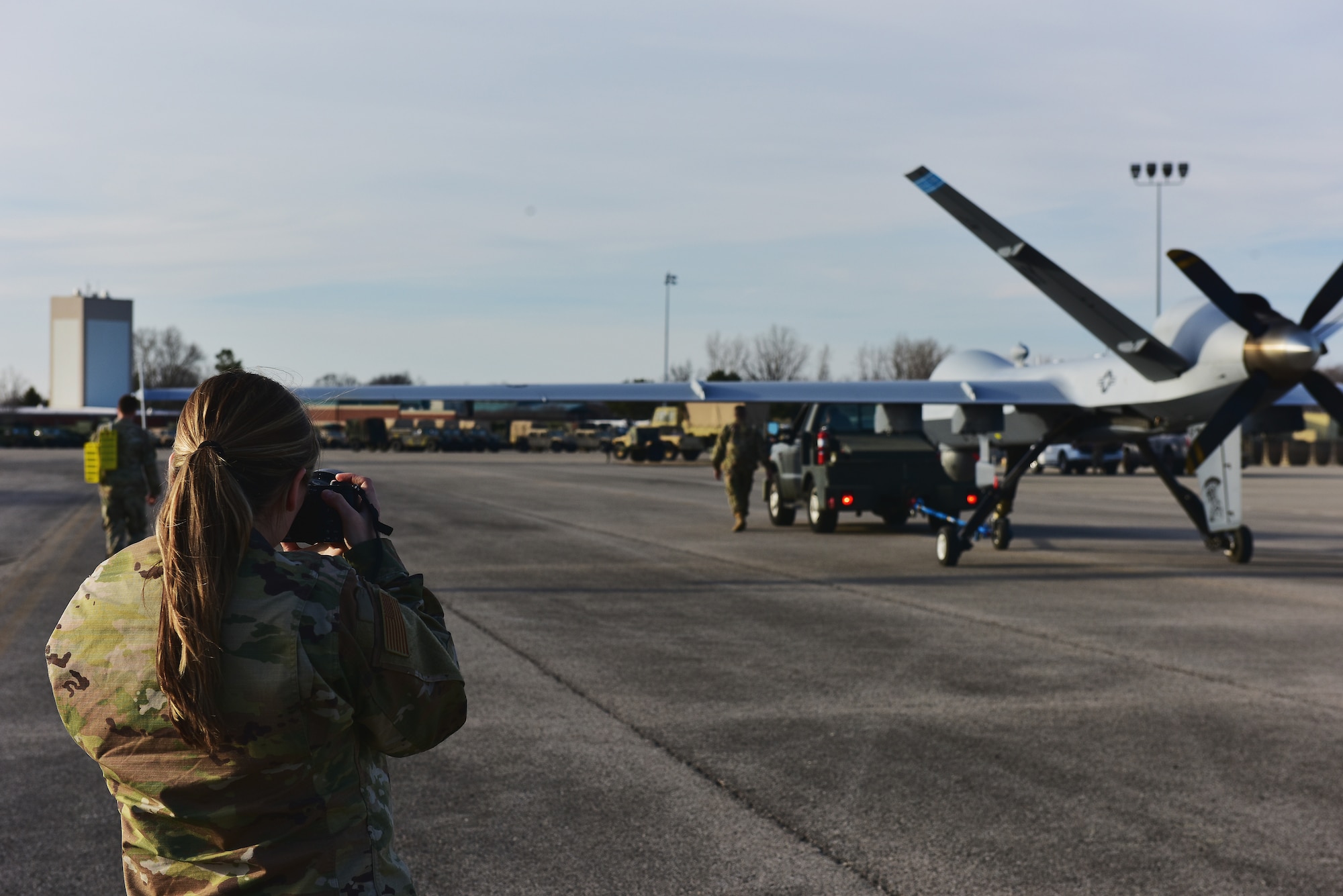 U.S. Air Force Staff Sgt. Tiffany Scofield, a public affairs specialist assigned to the178th Wing, photographs post-flight maintenance on an MQ-9 Reaper on Mar. 10, 2025  at Springfield-Beckley Air National Guard Base in Springfield, Ohio. The MQ-9 arrived for Advanced Wrath, a two-week exercise supporting U.S. Special Operations Command, U.S. Coast Guard search and rescue operations, and testing for the Air Force Research Laboratory. (U.S. Air National Guard photo by Shane Hughes)