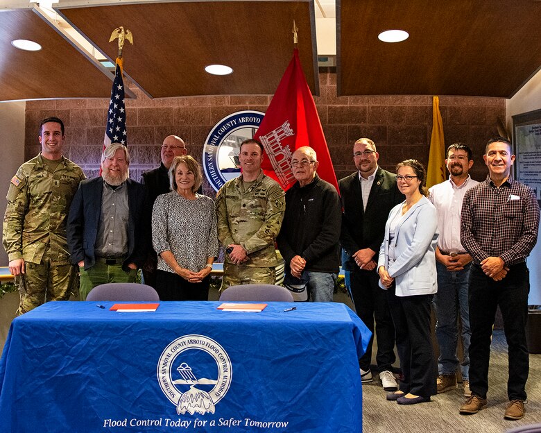 (L-R): 1st Lt. Garrett Falk, program manager, Albuquerque District; Jared Minor, chief, Civil Works, Albuquerque District; David Gatterman, executive engineer, SSCAFCA; Cassandra D’Antonio, chairperson, SSCAFCA board; Lt. Col. Matthew Miller, commander, Albuquerque District; Dr. James Fahey, mayor, Corrales, N.M.; Jacob Pauley, deputy for Planning Programs & Project Management, Albuquerque District; Khrysti Campana, chief, Resource Management, Albuquerque District; Andres Sanchez, chief of design, SSCAFCA; and Brian Sanchez, program manager, Albuquerque District; celebrate the signing of the PPA for construction of the Tortugas Arroyo Improvements Project, Dec. 16, 2024. Not Pictured: Martina Suazo, project manager, Albuquerque District.