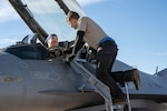 U.S. Air Force Col. Jeremiah “Weed” Tucker shakes hands with U.S. Air Force Staff Sgt. Matthew Lenker, crew chief, 140th Wing before departing for his fini flight following his recent relinquishing of command of the 140th Wing, Buckley Space Force Base, Aurora, Colorado, Feb. 13, 2025. Tucker promoted to brigadier general during a ceremony at the 140th Wing, March 1, 2025. (U.S. Air National Guard photos by Tech. Sgt. Chance Johnson)