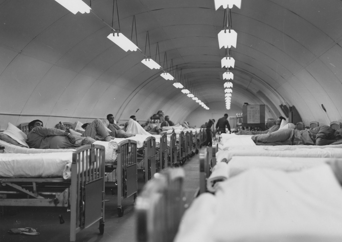 Historical image of service members in beds.