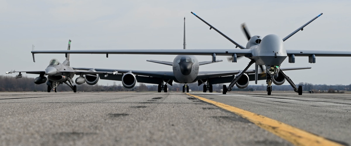 An MQ-9 Reaper assigned to the 178th Wing, a KC-135 Stratotanker from the 121st Air Refueling Wing and an F-16C Fighting Falcon from the 180th Fighter Wing participate in a close formation taxi commonly known as an "elephant walk", on Springfield-Beckley Air National Guard Base, March 19, 2024. This demonstration intended to highlight the Ohio Air National Guard's commitment to showcasing not just the strength and versatility of its aircraft, but the vital role they play in ensuring national security. (U.S. Air National Guard photo by Airman 1st Class Josh Kaeser)