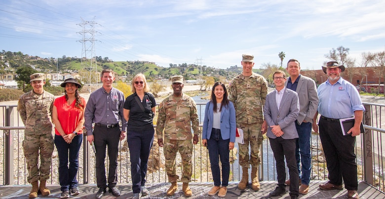 A group visiting key sites along the Los Angeles River are pictured together Feb. 27 on the pedestrian bridge overlooking the LA River next to LA’s historic Taylor Yard. From left to right: Capt. Victoria Amato, architect with the U.S. Army Corps of Engineers Los Angeles District’s Interagency Engineering Section; Priyanka Wadhawan, project manager with the LA District’s Mega Projects Division; Joseph Savage, programs director with USACE South Pacific Division; Robyn Colosimo, senior official performing the duties of the assistant secretary of the Army for Civil Works; Maj. Gen. Jason Kelly, USACE deputy commanding general for Civil and Emergency Operations; Mara Luevano, capital projects delivery manager for the City of LA; Col. Andrew Baker, LA District commander; Edward Belden, LA River Ecosystem Restoration project manager for the City of LA; Justin Gay, LA District deputy district engineer; and Paul Underwood, chief of the LA District’s Engineering Division. (Photo by Stephen Baack, USACE LA District.)