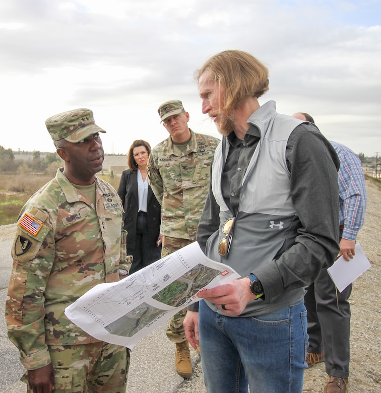 Aaron Smith, senior dam safety adviser with the U.S. Army Corps of Engineers, foreground-right, discusses the Whittier Narrows Dam Safety Modification Project with Maj. Gen. Jason Kelly, USACE deputy commanding general for Civil Works and Emergency Operations, left, during Kelly’s March 4 tour of the dam in Montebello, California. Kelly was accompanied by fellow USACE leaders and subject-matter experts from both the Los Angeles and Tulsa districts, as well as the South Pacific and Southwestern divisions.