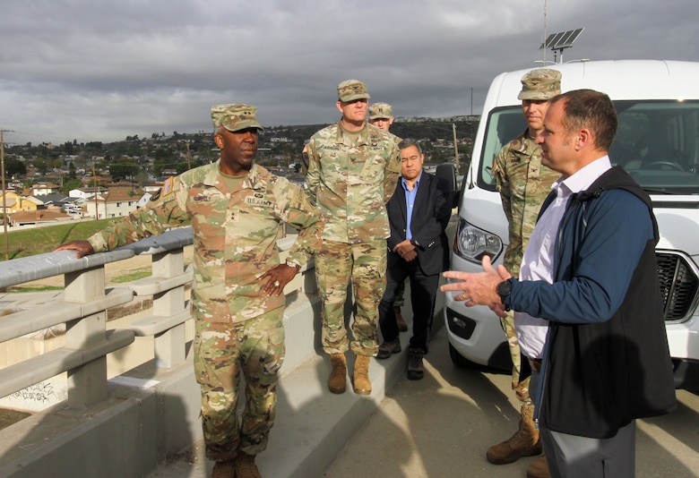 David Serafini, lead civil engineer with the U.S. Army Corps of Engineers Risk Management Center, right, talks with Maj. Gen. Jason Kelly, U.S. Army Corps of Engineers deputy commanding general for Civil Works and Emergency Operations, while overlooking the Rio Hondo tributary from atop the dam March 4 in Montebello, California.