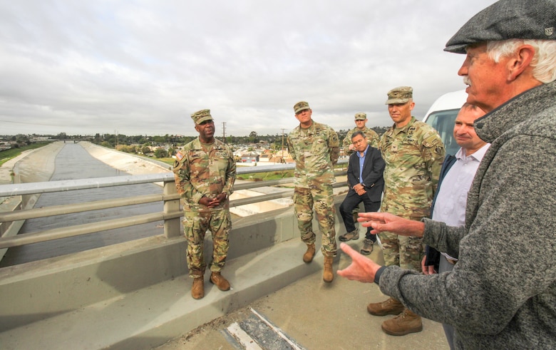 Doug Chitwood, U.S. Army Corps of Engineer Los Angeles District lead project engineer for the Whittier Narrows Dam Safety Modification Project, right, talks with Maj. Gen. Jason Kelly, USACE deputy commanding general for Civil Works and Emergency Operations, left, while overlooking the Rio Hondo tributary from atop the dam March 4 in Montebello, California. The discussion was part of a tour of the dam for Kelly, who was accompanied by fellow USACE leaders and subject-matter experts from both the Los Angeles and Tulsa districts, as well as the South Pacific and Southwestern divisions.