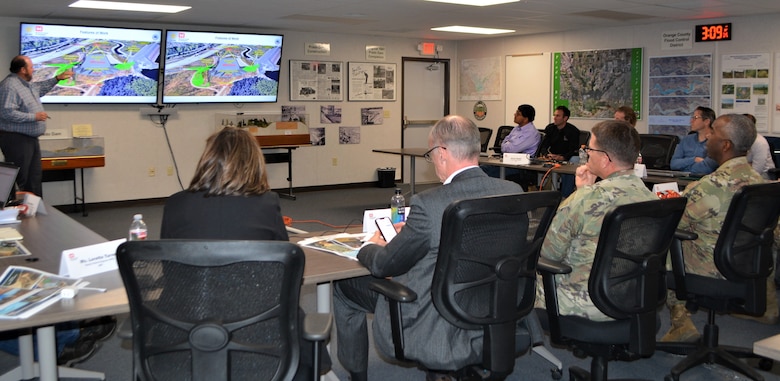 Brian Dillard, chief engineer for the California Mega Project Office, Southwest Division Dam Safety Production Center, background left, discusses the Prado Dam Spillway Modification Project with Maj. Gen. Jason Kelly, U.S. Army Corps of Engineers deputy commanding general for Civil Works and Emergency Operations, foreground right, March 4 at Prado Dam in Corona, California.
