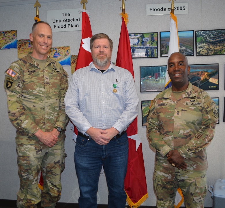 From left to right, Col. Andrew Baker, LA District commander; Derek Walker, LA District project manager for the Santa Ana River Mainstem Project; and Maj. Gen. Jason Kelly, U.S. Army Corps of Engineers deputy commanding general for Civil Works and Emergency Operations, pose for a picture March 4 after Walker received a Civilian Service Commendation Medal for his work on the project at the Prado Dam Resident Office in Corona, California.