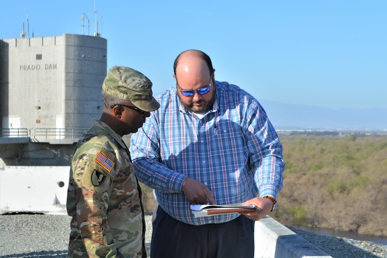 Brian Dillard, chief engineer for the California Mega Project Office, Southwest Division Dam Safety Production Center, right, discusses the Prado Dam Spillway Modification Project with Maj. Gen. Jason Kelly, U.S. Army Corps of Engineers deputy commanding general for Civil Works and Emergency Operations, left, March 4 at Prado Dam in Corona, California.