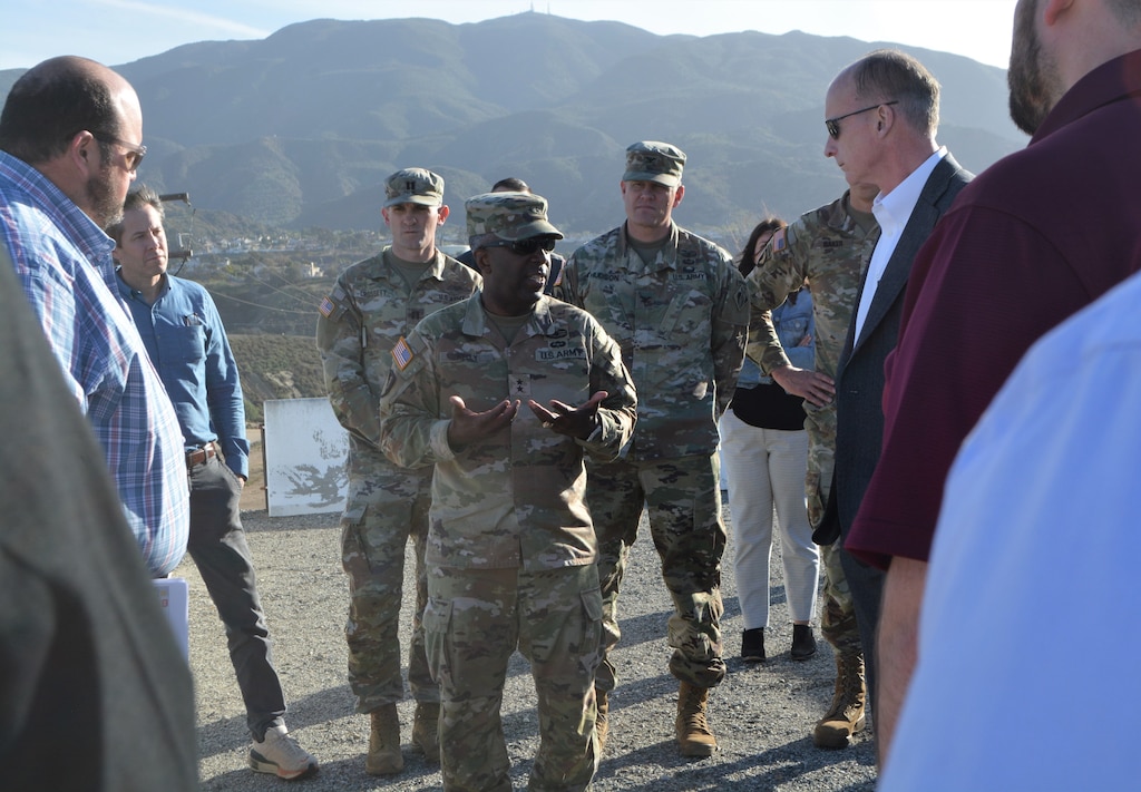 Maj. Gen. Jason Kelly, U.S. Army Corps of Engineers deputy commanding general for Civil Works and Emergency Operations, center, talks to engineers, and program and project managers for the Prado Dam Spillway Modification Project during a March 4 visit to Prado Dam in Corona, California.