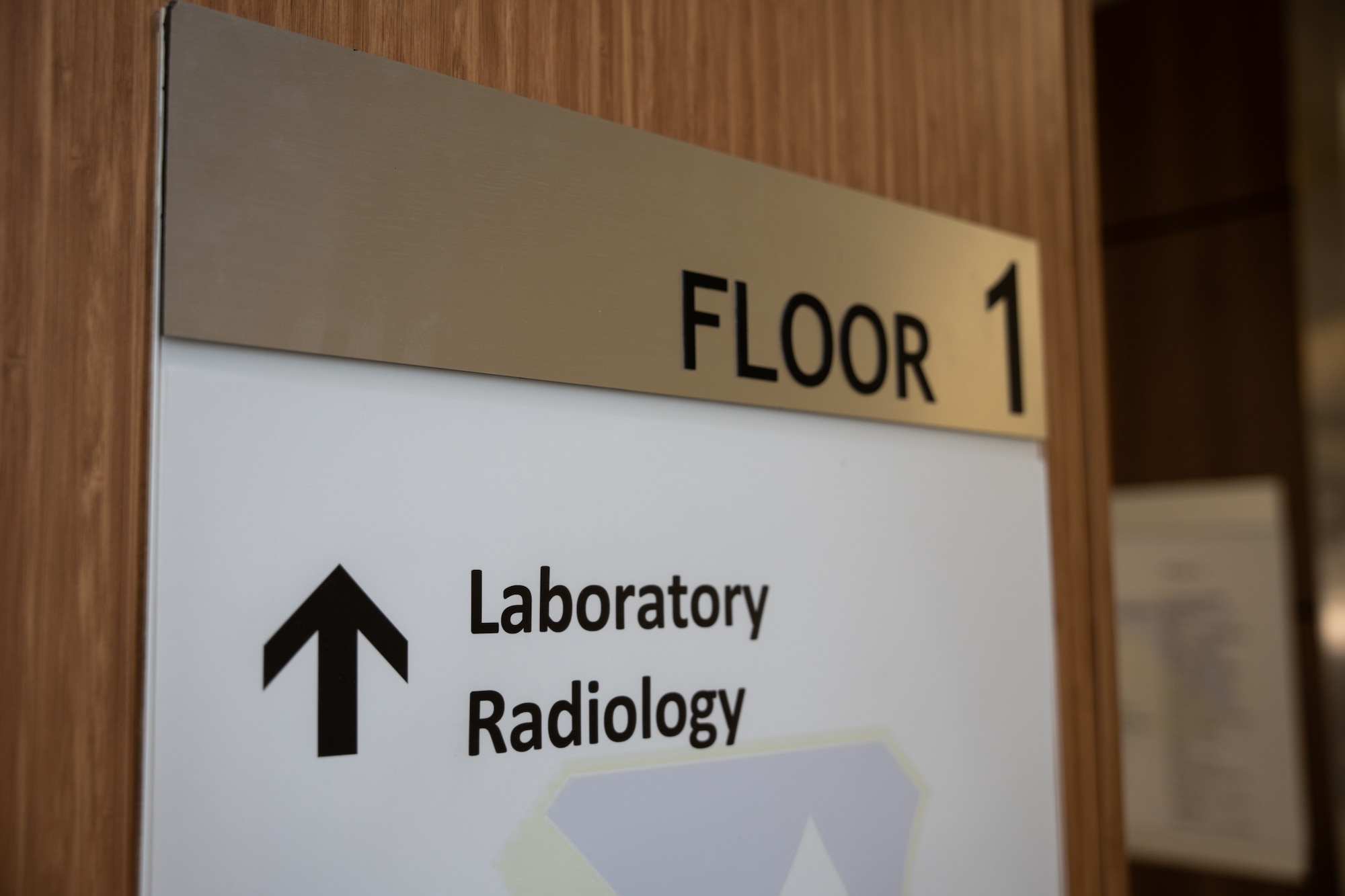 A sign reading "Floor 1 - Laboratory Radiology" hangs on the wall.