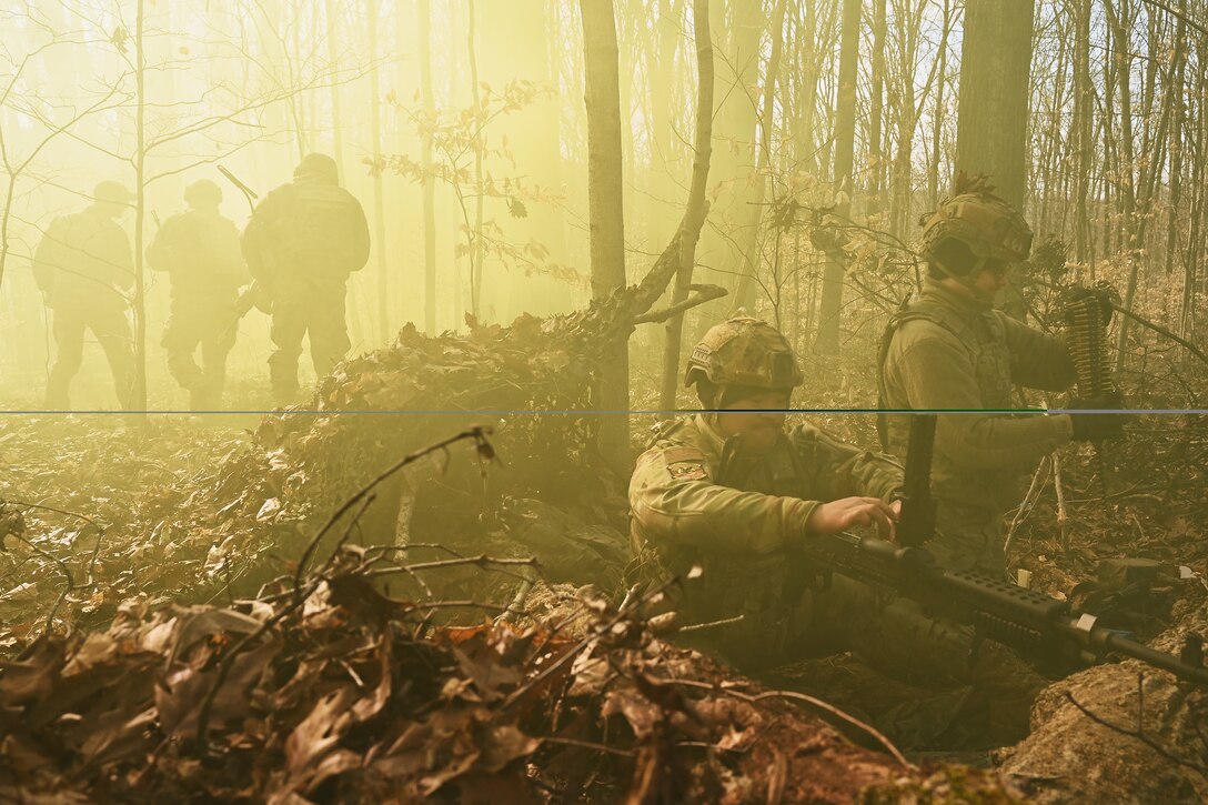 U.S. Airmen assigned to the 178th Security Forces Squadron, Ohio National Guard defend their fighting position against a simulated enemy attack Feb. 4, 2025 during annual training at Camp Holland in Butlerville, Indiana. The training, primarily focused on mission planning, included attacking and defending positions and aligning tactics with the Air Force doctrine of Agile Combat Employment. (U.S. Air National Guard photo by Shane Hughes)
