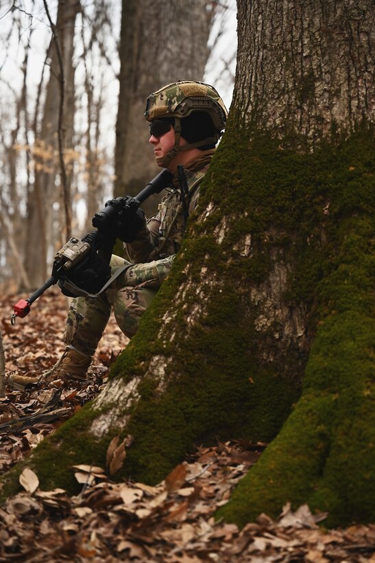 A U.S. Airman assigned to the 178th Security Forces Squadron, Ohio Air National Guard scans the woods for potential threats Feb. 4, 2025 during annual training at Camp Holland in Butlerville, Indiana. The training, primarily focused on mission planning, taught Airmen how mission type orders communicate the purpose of the operation, desired end states, the method designed to conduct it, and the resources available for execution. (U.S. Air National Guard photo by Shane Hughes)
