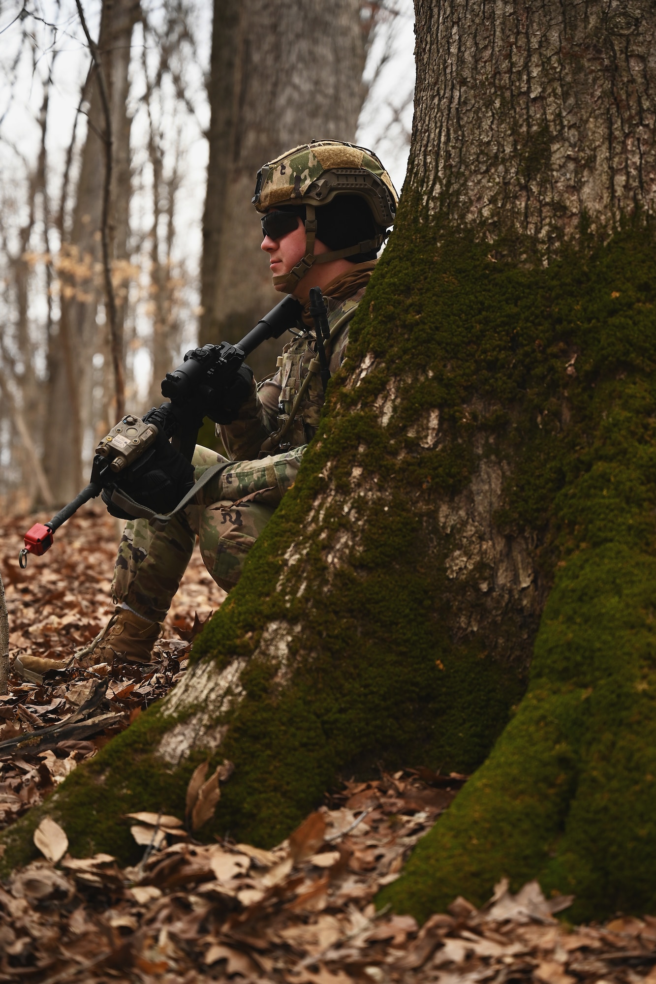 A U.S. Airman assigned to the 178th Security Forces Squadron, Ohio Air National Guard scans the woods for potential threats Feb. 4, 2025 during annual training at Camp Holland in Butlerville, Indiana. The training, primarily focused on mission planning, taught Airmen how mission type orders communicate the purpose of the operation, desired end states, the method designed to conduct it, and the resources available for execution. (U.S. Air National Guard photo by Shane Hughes)