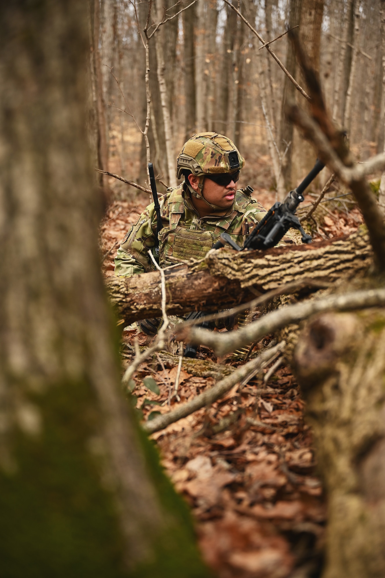 A U.S. Airman assigned to the 178th Security Forces Squadron, Ohio Air National Guard scans the woods for potential threats Feb.4, 2025 during annual training at Camp Holland in Butlerville, Indiana. The training, primarily focused on mission planning, taught Airmen how mission type orders communicate the purpose of the operation, desired end states, the method designed to conduct it, and the resources available for execution. (U.S. Air National Guard photo by Shane Hughes)