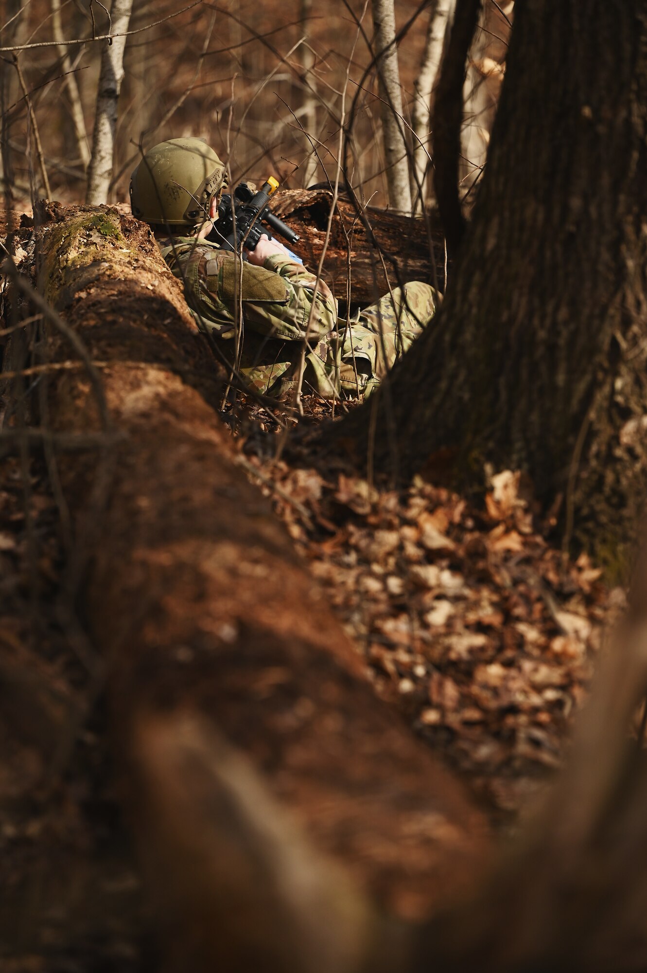 A U.S. Airman assigned to the 178th Security Forces Squadron, Ohio Air National Guard scans the woods for potential threats Feb. 3, 2025 during annual training at Camp Holland in Butlerville, Indiana. The training, primarily focused on mission planning, included classes on mission-type orders, starting with a standard 5-paragraph operations order to provide a snapshot of the commander’s intent. (U.S. Air National Guard photo by Shane Hughes)