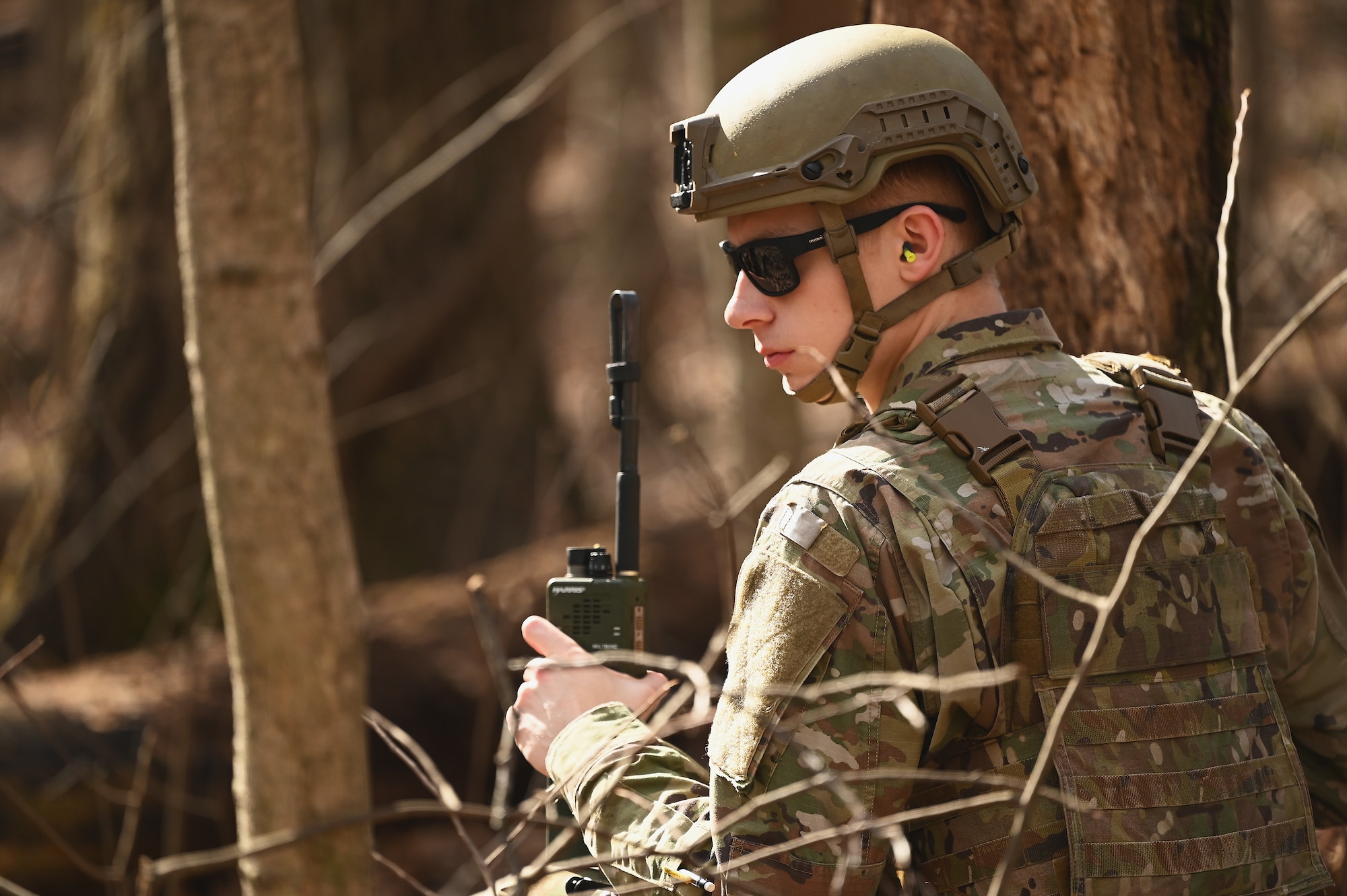 A U.S. Airman assigned to the 178th Security Forces Squadron, Ohio Air National Guard calls in a potential threat Feb. 3, 2025 during annual training at Camp Holland in Butlerville, Indiana. The training, primarily focused on mission planning, showed Airmen how to rapidly execute operations from various locations with integrated capabilities and interoperability across core functions.. (U.S. Air National Guard photo by Shane Hughes)