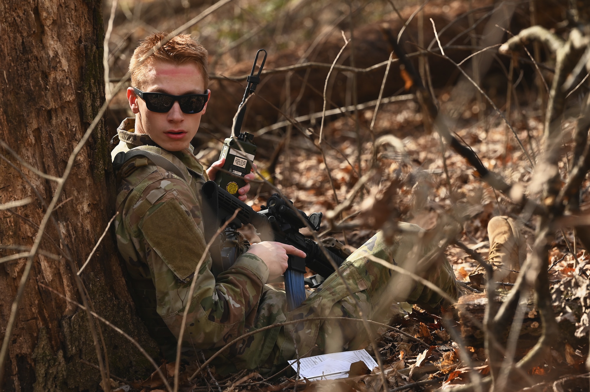 A U.S. Airmen assigned to the 178th Security Forces Squadron, Ohio Air National Guard scans the woods for potential threats Feb. 3, 2025 during annual training at Camp Holland in Butlerville, Indiana. The training, primarily focused on mission planning, included helping Airmen understand enemy situation, friendly situation, joint force and air component operational priorities, phasing and sequencing of the operation, logistical and sustainment priorities, delegated authorities, and overall risk management.  (U.S. Air National Guard photo by Shane Hughes)