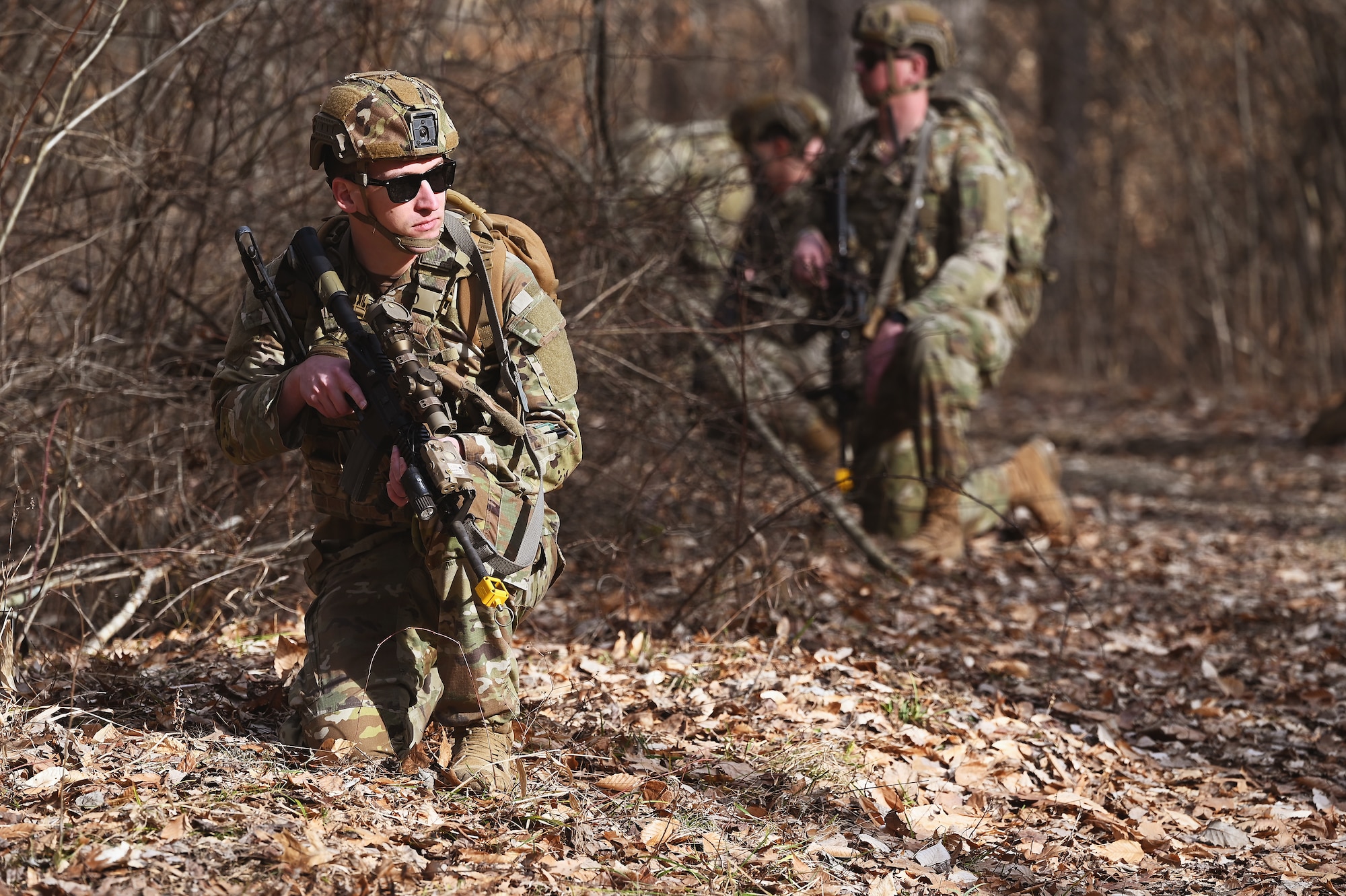 U.S. Airmen assigned to the 178th Security Forces Squadron, Ohio Air National Guard scan the woods for potential threats on their way to their mission objective Feb. 3, 2025 during annual training at Camp Holland in Butlerville, Indiana. The training focused on empowering subordinates at the lowest capable level to make decisions and take decisive action at their level and providing the flexibility and agility required to seize opportunities despite enemy denial or degradation of communications.