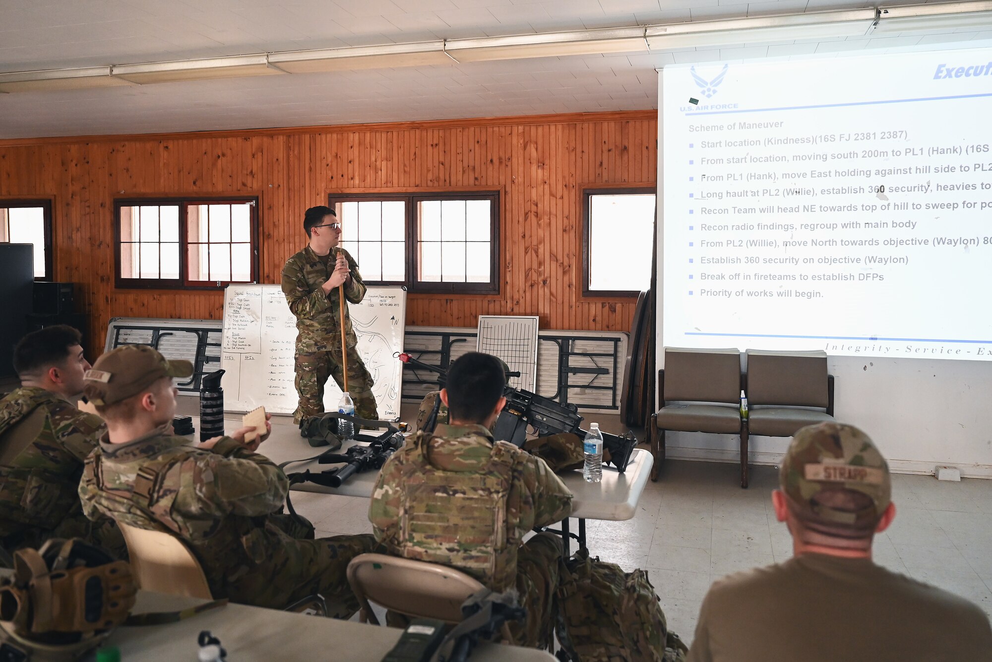 U.S. Airmen assigned to the 178th Security Forces Squadron, Ohio Air National Guard receive a mission briefing Feb. 3, 2025 during annual training at Camp Holland in Butlerville, Indiana. The training focused on ways to identify how to minimize equipment and personnel footprints to increase dispersal capabilities and complicate adversary targeting. (U.S. Air National Guard photo by Shane Hughes)