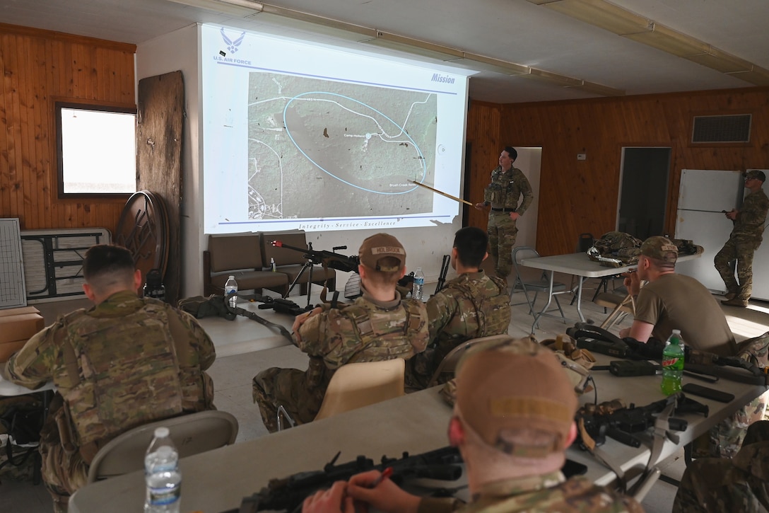 U.S. Airmen assigned to the 178th Security Forces Squadron, Ohio Air National Guard receive a mission briefing Feb. 3, 2025 during annual training at Camp Holland in Butlerville, Indiana. The training focused on ways to identify how to minimize equipment and personnel footprints to increase dispersal capabilities and complicate adversary targeting. (U.S. Air National Guard photo by Shane Hughes)