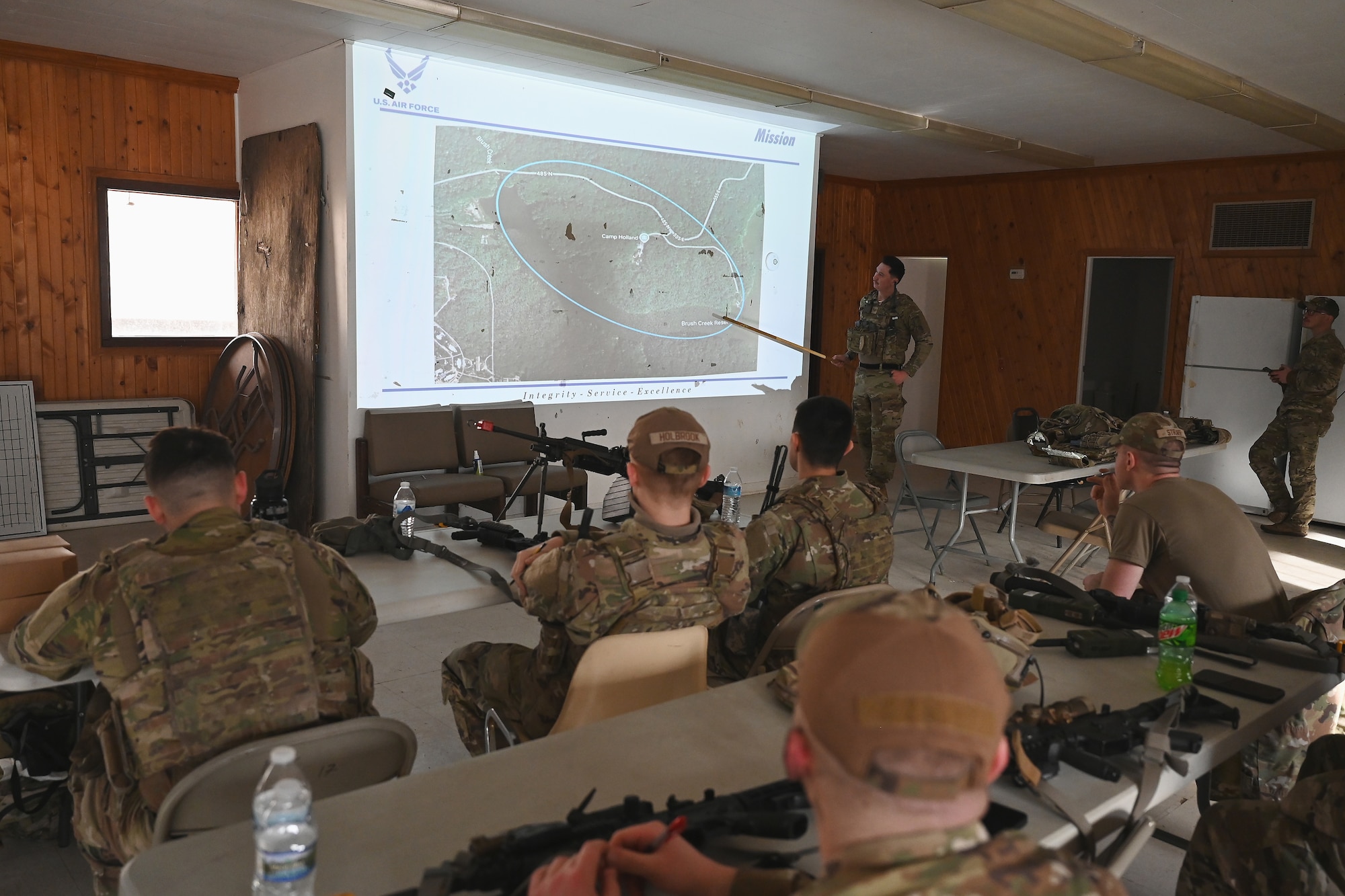 U.S. Airmen assigned to the 178th Security Forces Squadron, Ohio Air National Guard receive a mission briefing Feb. 3, 2025 during annual training at Camp Holland in Butlerville, Indiana. The training focused on ways to identify how to minimize equipment and personnel footprints to increase dispersal capabilities and complicate adversary targeting. (U.S. Air National Guard photo by Shane Hughes)