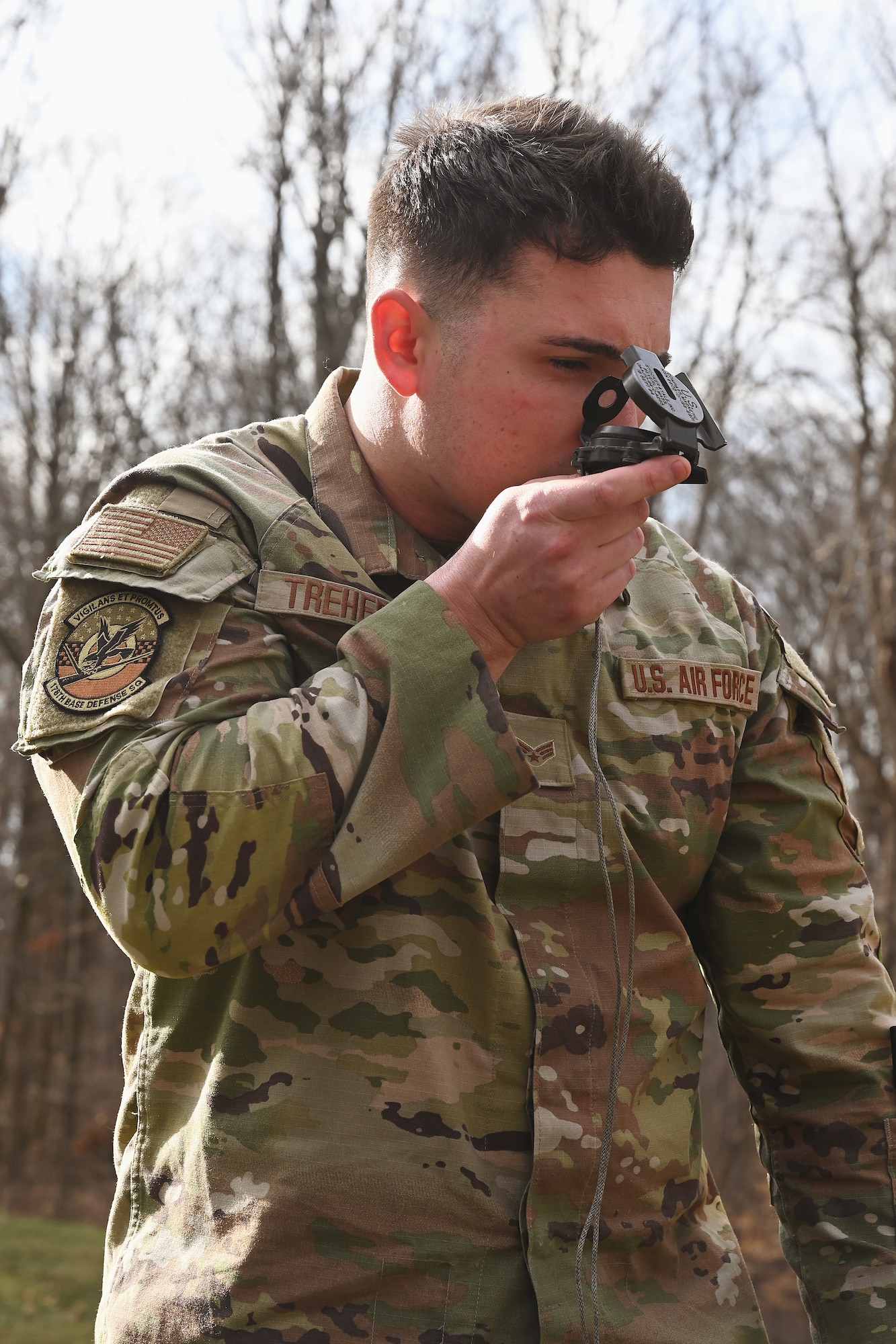 U.S. Air Force Senior Airman Ty Treherne, a security forces specialist assigned to the 178th Security Forces Squadron, Ohio Air National Guard, uses a land navigation compass Feb. 2, 2025 during annual training at Camp Holland in Butlerville, Indiana. Agile Combat Employment is a war-fighting concept focused on ways to reduce the number of people who must be put in harm’s way to generate airpower relative to traditional manning models.. (U.S. Air National Guard photo by Shane Hughes)