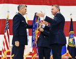 Col. David Leaumont unfurls the 95th Wing guidon