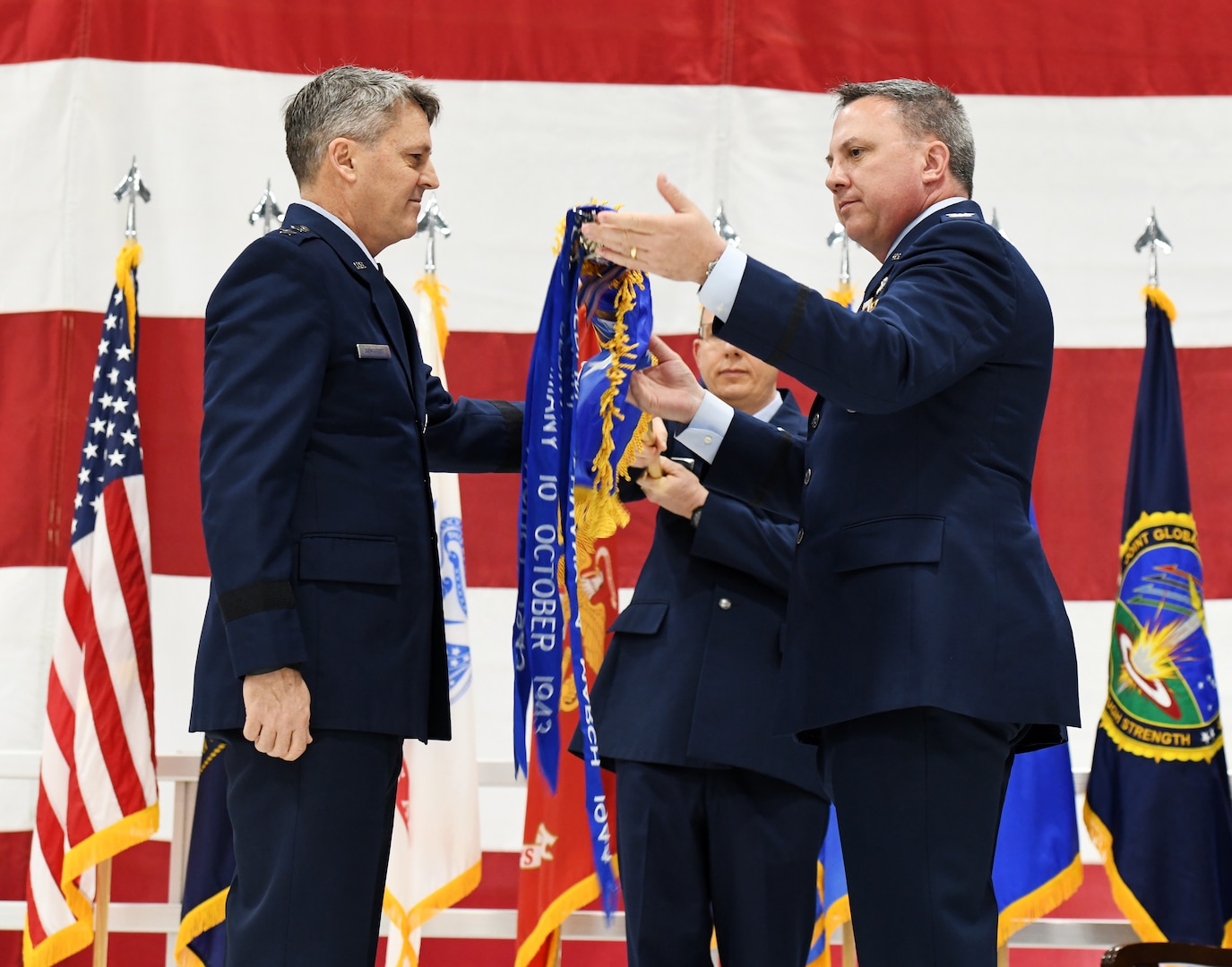 Col. David Leaumont unfurls the 95th Wing guidon