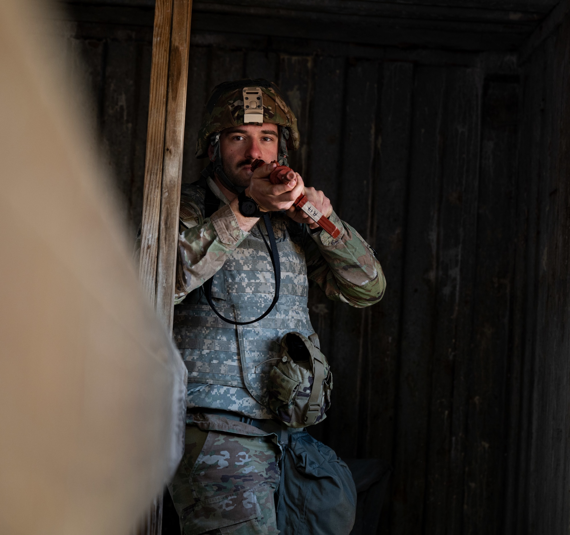 Airman 1st Class Spencer Smith, 509th Civil Engineering squadron heating, ventilation, and air-conditioning technician, goes through a shoot house during a field training exercise in Macon, Mo., March 12, 2025. The exercise tested warfighter readiness by simulating austere environments and complex enemy engagements, pushing participants to adapt and overcome challenges. (U.S. Air Force photo by Senior Airman Bryson Sherard)