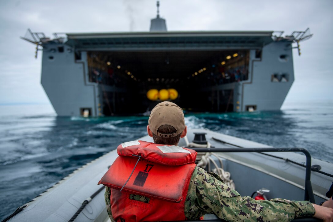 Machinist Mate 2nd Class Jacob Warner, assigned to amphibious transport dock USS Somerset (LPD 25), participates in small boat operations while NASA engineers prepare to release a crew module test article from the ship’s well deck during NASA Underway Recovery Test 12 in the Pacific Ocean, March 26, 2025.