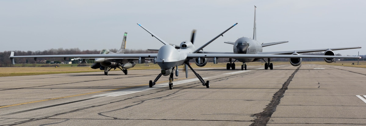 An MQ-9 Reaper assigned to the 178th Wing, a KC-135 Stratotanker from the 121st Air Refueling Wing and a F-16 Fighting Falcon from the 180th Fighter Wing  participate in a close formation taxi commonly known as an "elephant walk", on Springfield-Beckley Air National Guard Base, March 19, 2024. Members of the Ohio Air National Guard participated in Advanced Wrath, a two-week exercise supporting U.S. Special Operations Command, U.S. Coast Guard search and rescue operations, and testing for the Air Force Research Laboratory. (U.S. Air National Guard photo by Airman 1st Class Josh Kaeser)
