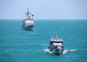 The Ticonderoga-class guided-missile cruiser USS Normandy (CG 60) conducts a passing exercise with Guyana Defense Force Defiant-class patrol ship GDSF Shahoud in the Caribbean Sea, March 27, 2025. Normandy is scheduled to protect U.S. interests in the region and strengthen maritime partnerships through bilateral and multinational maritime operations and Theater Security Cooperation port visits. U.S. Naval Forces Southern Command/U.S. 4th Fleet is the maritime component of U.S. Southern Command and the trusted maritime partner for Caribbean, Central, and South American maritime forces, leading to improved unity, security, and stability. (U.S. Navy photo by Mass Communication Specialist 2nd Class Dylan M. Kinee/Released)