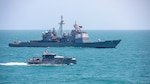 The Ticonderoga-class guided-missile cruiser USS Normandy (CG 60) conducts a passing exercise with Guyana Defense Force Defiant-class patrol ship GDSF Shahoud in the Caribbean Sea, March 27, 2025. Normandy is scheduled to protect U.S. interests in the region and strengthen maritime partnerships through bilateral and multinational maritime operations and Theater Security Cooperation port visits. U.S. Naval Forces Southern Command/U.S. 4th Fleet is the maritime component of U.S. Southern Command and the trusted maritime partner for Caribbean, Central, and South American maritime forces, leading to improved unity, security, and stability. (U.S. Navy photo by Mass Communication Specialist 2nd Class Dylan M. Kinee/Released)