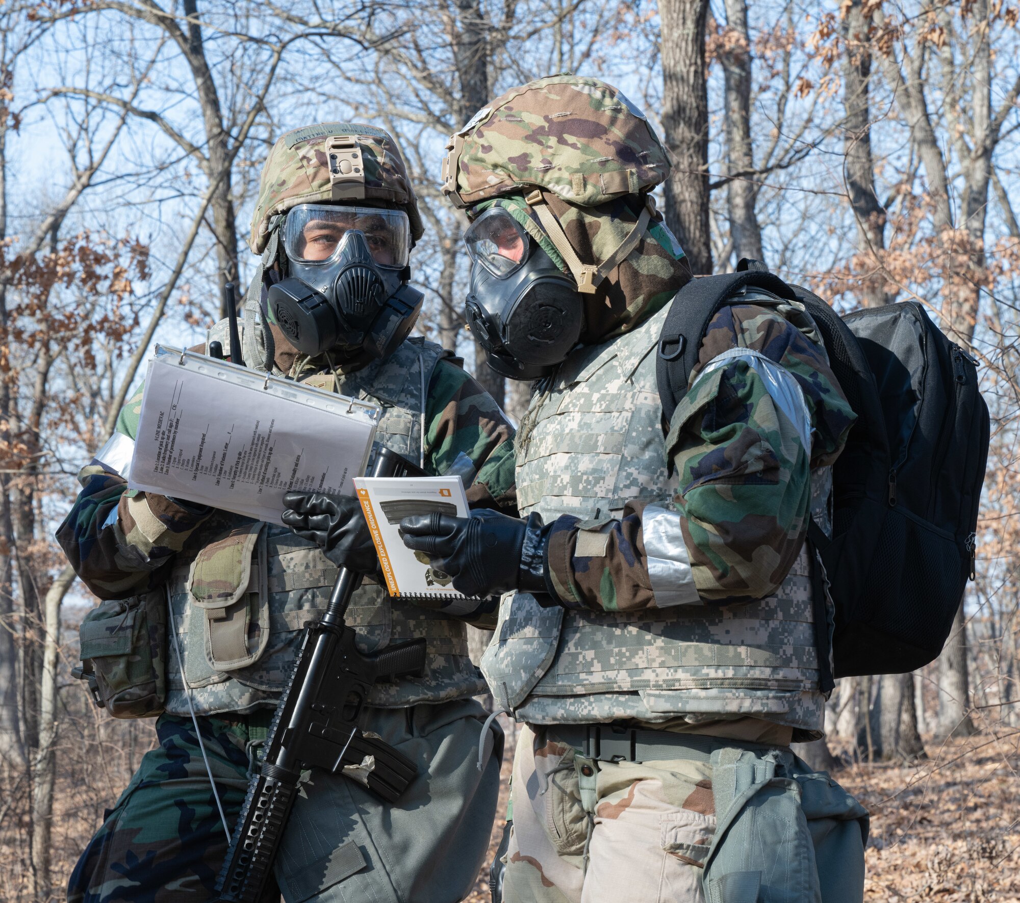 Senior Airman Trent Holmes, 509th Civil Engineering squadron water and fuel systems maintenance specialist, and Airman 1st Class Matthew Melendez, 509th Civil Engineering squadron structures technician, conduct a post-attack reconnaissance sweep during a field training exercise in Macon, Mo., March 13, 2025. The exercise tested warfighter readiness by simulating austere environments and complex enemy engagements, pushing participants to adapt and overcome challenges. (U.S. Air Force photo by Senior Airman Bryson Sherard)