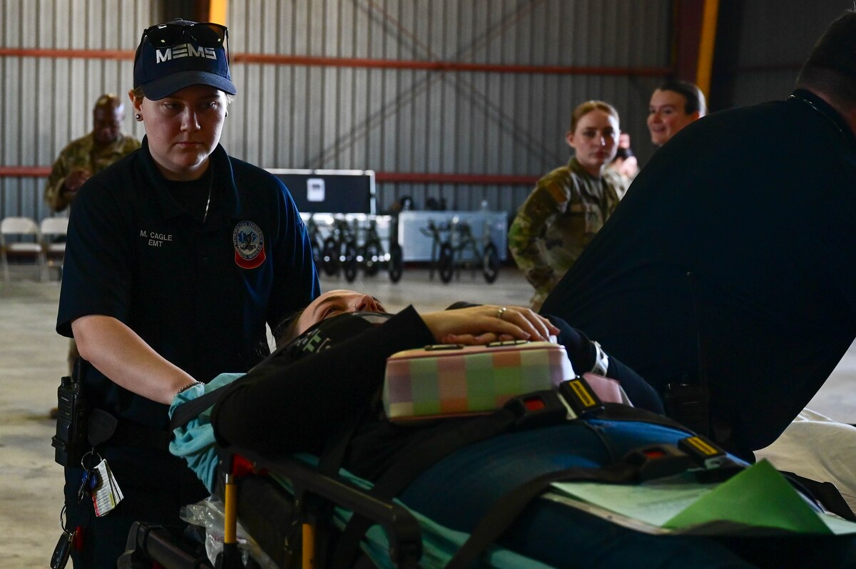 An emergency service member transports a patient.