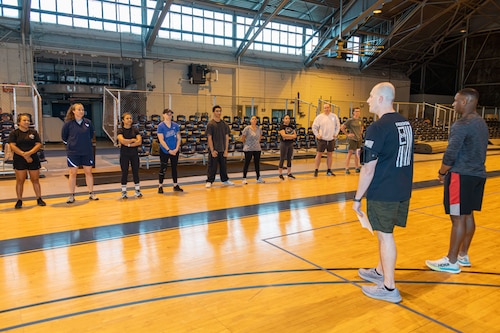 TSgt Christopher Thomas and TSgt Fabion Hawthorne, both of Air Force Life Cycle Management Center, instruct participants before the start of the Memorial Workout Initiative at Maxwell Air Force Base, Alabama, on March 28, 2025.