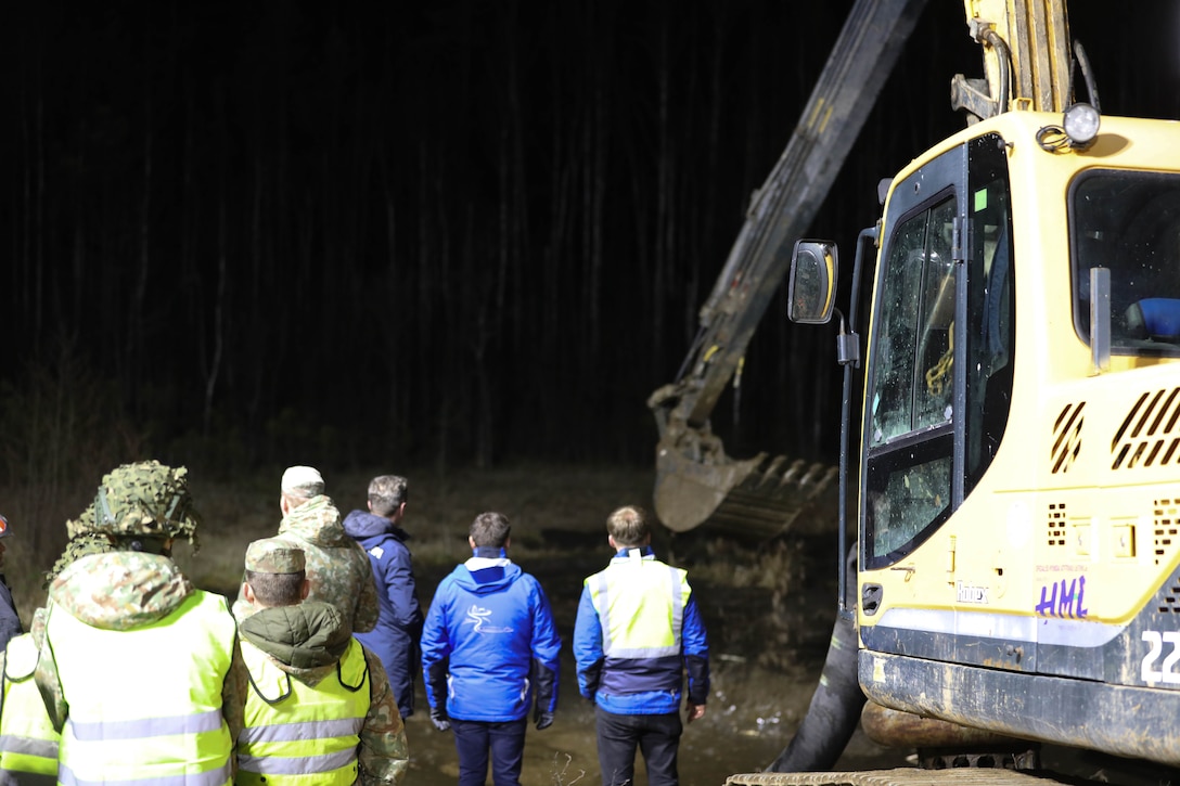 Lithuanian Armed Forces personnel and emergency services, clear debris through the night as part of recovery efforts for a U.S. Army M88 Hercules recovery vehicle submerged under several meters of water in a swamp near a training area in Pabradė, Lithuania, March 28, 2025. (U.S. Army photo by Staff Sgt. Rose Di Trolio)
