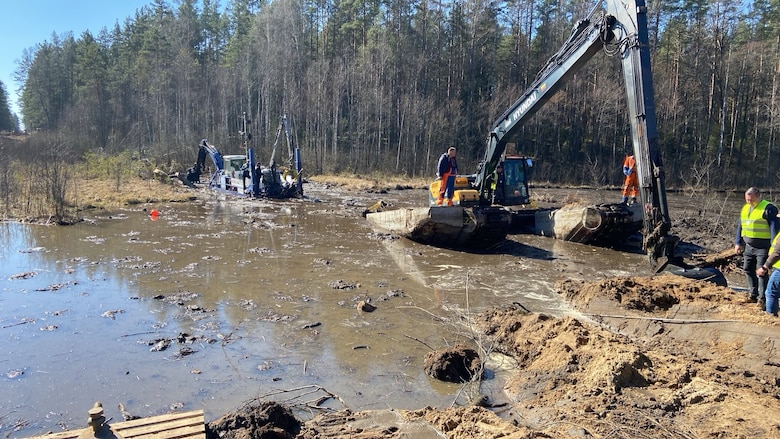 Lithuanian Armed Forces personnel and emergency services clear debris as part of recovery efforts for a U.S. Army M88 Hercules recovery vehicle submerged under several meters of water in a swamp near a training area in Pabradė, Lithuania, March 29, 2025.