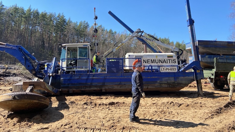 Lithuanian Armed Forces personnel and emergency services clear debris as part of recovery efforts for a U.S. Army M88 Hercules recovery vehicle submerged under several meters of water in a swamp near a training area in Pabradė, Lithuania, March 29, 2025.