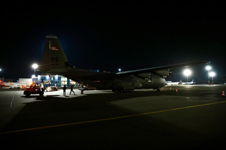 U.S. Air Force members from 37th Airlift Squadron work late into the night to unload diving equipment from a U.S. Air Force C-130 Hercules aircraft at Vilnius International Airport to be used in the ongoing efforts to recover four U.S. soldiers in a submerged M88 Hercules on a training site near Pabadre, Lithuania on March 29, 2025.