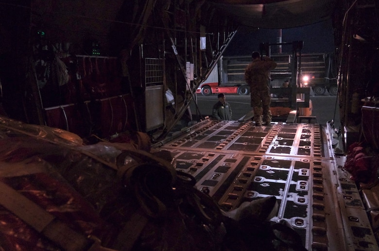 U.S. Air Force members from 37th Airlift Squadron work late into the night to unload diving equipment from a U.S. Air Force C-130 Hercules aircraft at Vilnius International Airport to be used in the ongoing efforts to find four U.S. soldiers in a submerged M88 Hercules on a training site near Pabadre, Lithuania on March 29, 2025.